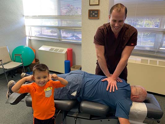 Chiropractor Falls Church VA Michael Armellino Adjusting Patient And Child Chiropractor Falls Church VA Michael Armellino Adjusting Patient And Child